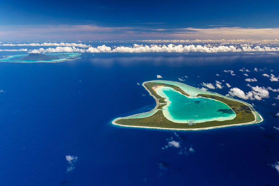 Soar over the hear-shaped island of Tupai from Bora Bora | Travel Nation