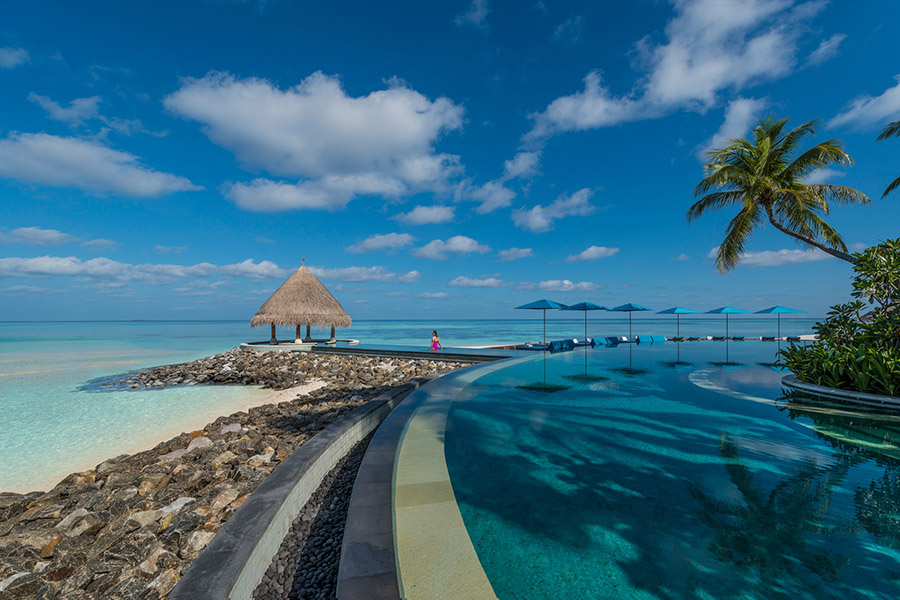 Take a swim in the infinity pool at the Four Seasons Kuda Huraa in the Maldives | Photo credit: Four Seasons