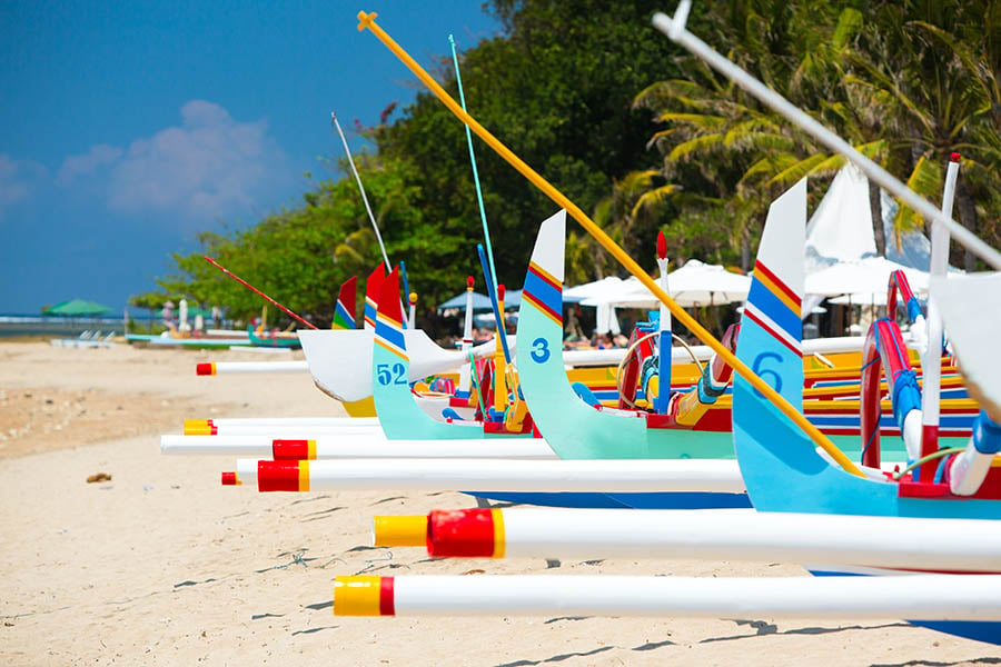 Discover the colourful boats situated on Sanur's sandy beach