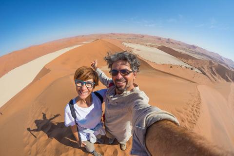 Couple taking selfie at Sossuvlei, Namibia | Travel Nation