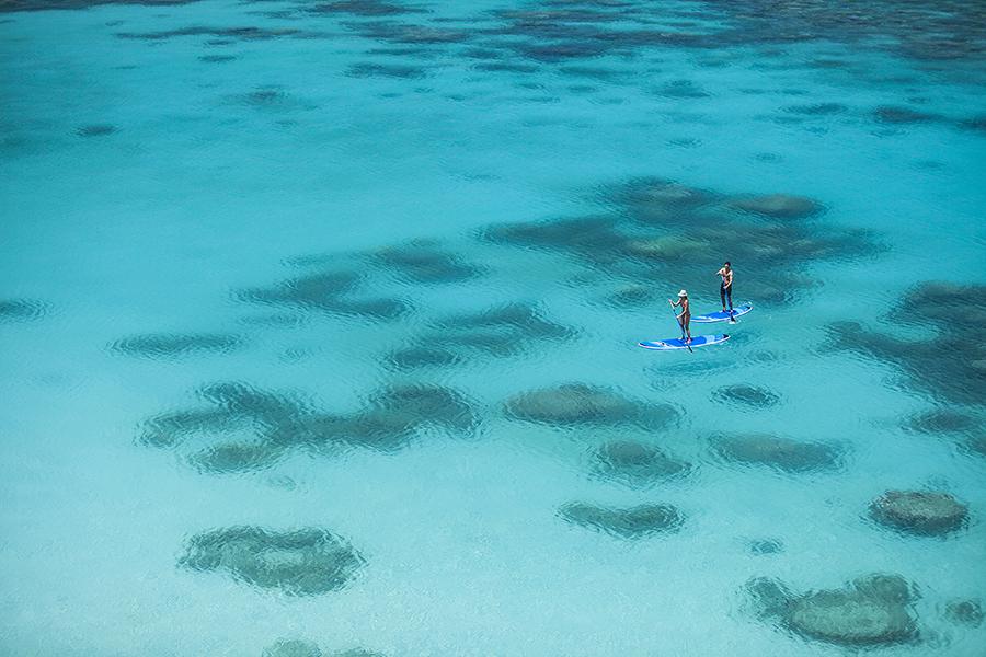 Paddle board over the Great Barrier Reef at Lizard Island | Photo credit: Lizard Island 