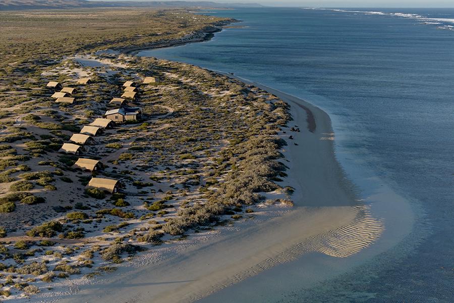 Relax on the stunning Ningaloo Reef coastline at Sal Salis | Photo credit: Sal Salis