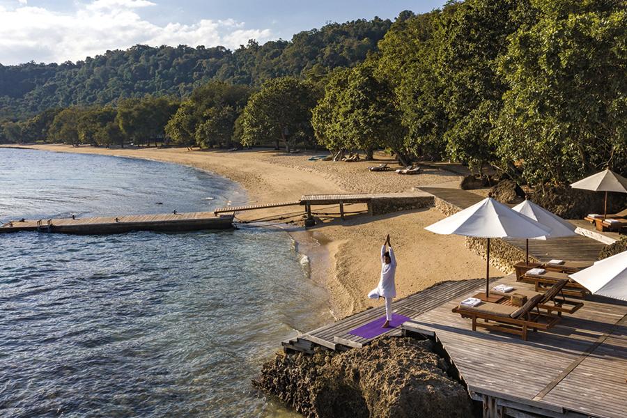Practice yoga by the quiet beach at Amanwana | Photo credit: Amanwana