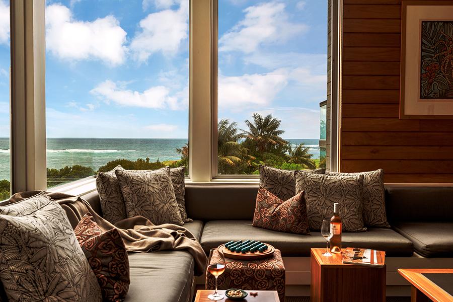 Enjoy mountain and reef views, cozy fireplaces, drinks, books, and board games— all in the relaxed atmosphere of the Kentia Lounge at Capella Lodge | Photo credit: Capella Lodge