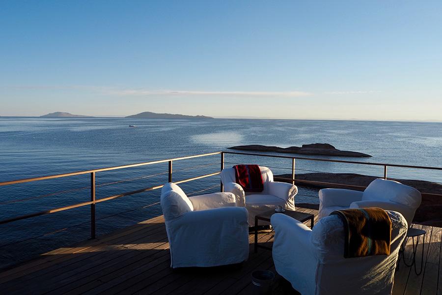 Sit in comfort on Titilaka's overwater deck with stunning lake views | Photo credit: Titilaka Lodge