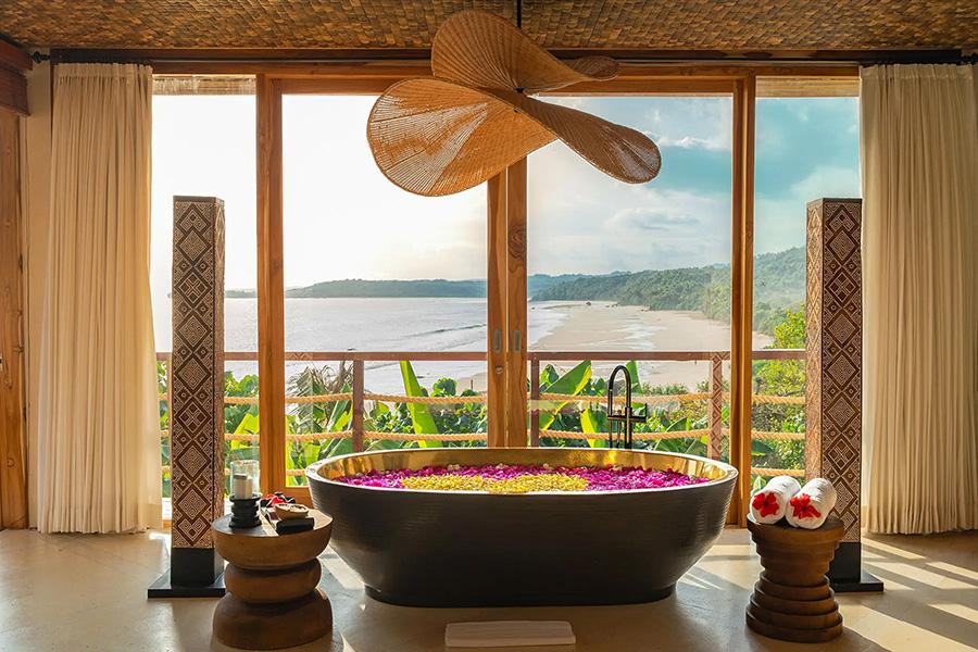 Unwind in your large petal filled bath in the Puti Kasambi Villa at Nihi Sumba | Photo credit: Nihi Sumba
