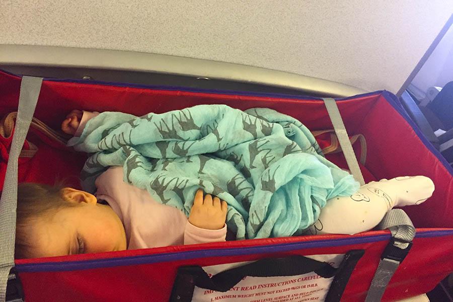 Baby Freya asleep in her airline bassinet | Travel Nation 