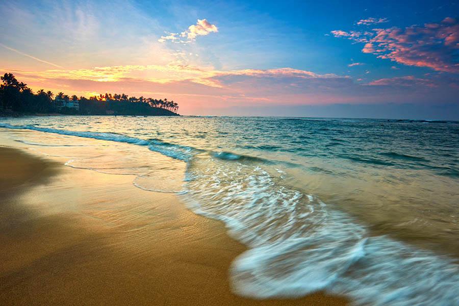 Watch the sunset from the sand on Mirissa beach
