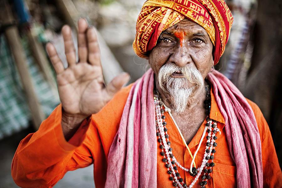 Sadhus (holy men) and pilgrims mix with tourists along the river at dusk 