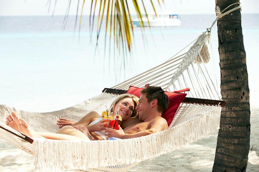 Couple relaxing in hammock