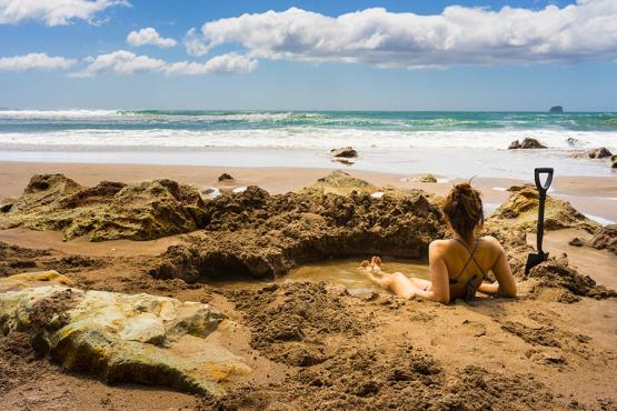 Dig your own spa hole on Hot Water Beach, New Zealand | Travel Nation