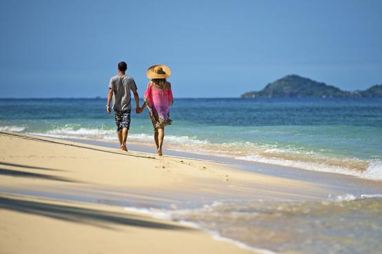 Couple walking along a deserted beach 